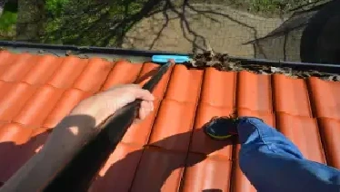 professional cleaning a gutter.